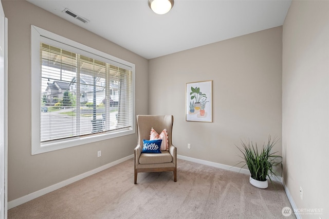 sitting room featuring carpet flooring and baseboards