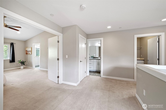 corridor featuring light carpet, baseboards, and recessed lighting