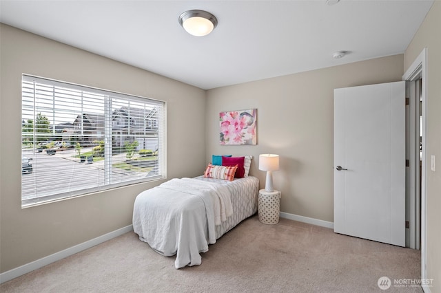 carpeted bedroom with baseboards