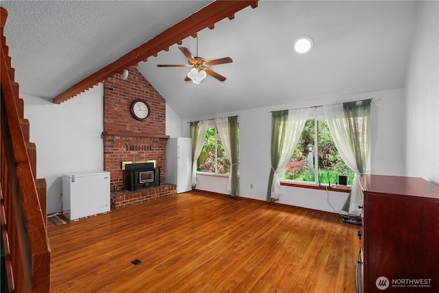 130 E Agate Dr, Shelton, WA 98584 - unfurnished living room featuring a wood stove, wood finished floors, and ceiling fan