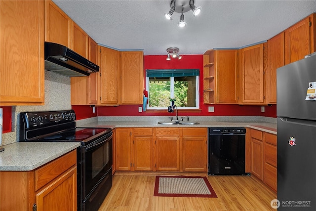 130 E Agate Dr, Shelton, WA 98584 - kitchen featuring black appliances, under cabinet range hood, a sink, light wood-style floors, and a textured ceiling