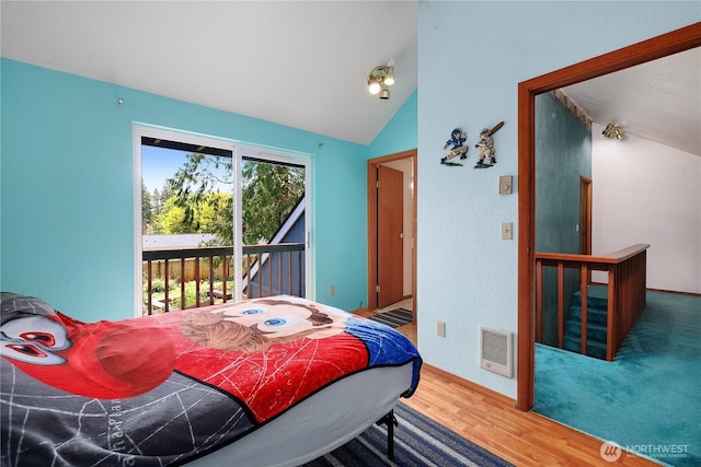 130 E Agate Dr, Shelton, WA 98584 - bedroom with access to exterior, wood finished floors, lofted ceiling, baseboards, and heating unit