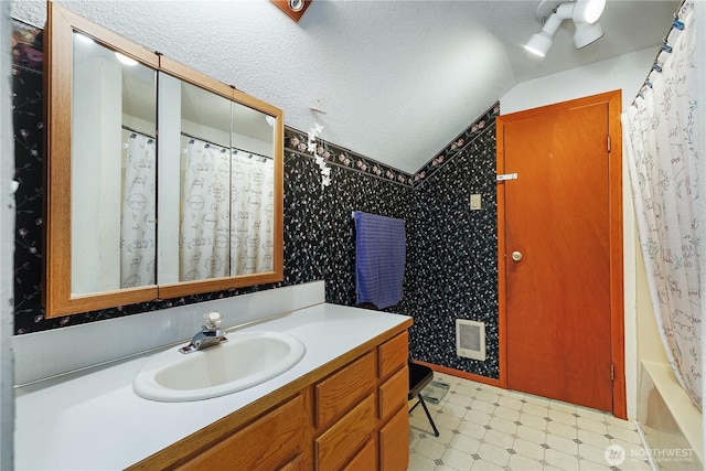 130 E Agate Dr, Shelton, WA 98584 - full bath with vanity, vaulted ceiling, tile patterned floors, and a textured ceiling