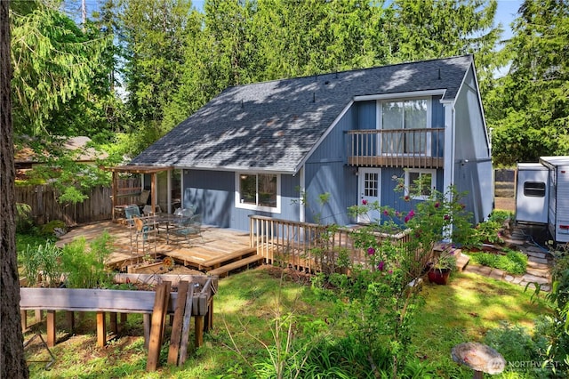 130 E Agate Dr, Shelton, WA 98584 - back of property featuring a shingled roof, a balcony, and a deck