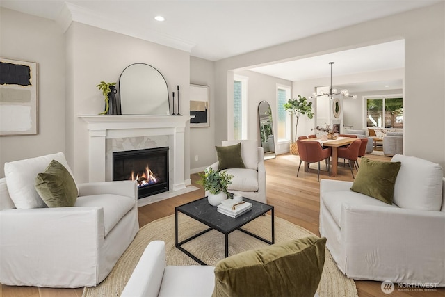 3815 NE 89th St, Seattle, WA 98115 - living room with a fireplace, wood finished floors, a chandelier, recessed lighting, and baseboards