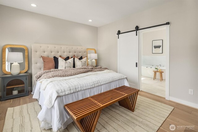 3815 NE 89th St, Seattle, WA 98115 - bedroom with a barn door, light wood-style floors, recessed lighting, and baseboards