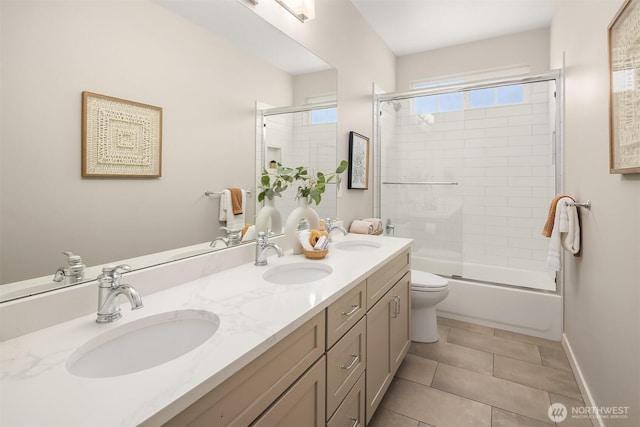 3815 NE 89th St, Seattle, WA 98115 - full bath featuring double vanity, tile patterned flooring, toilet, enclosed tub / shower combo, and baseboards