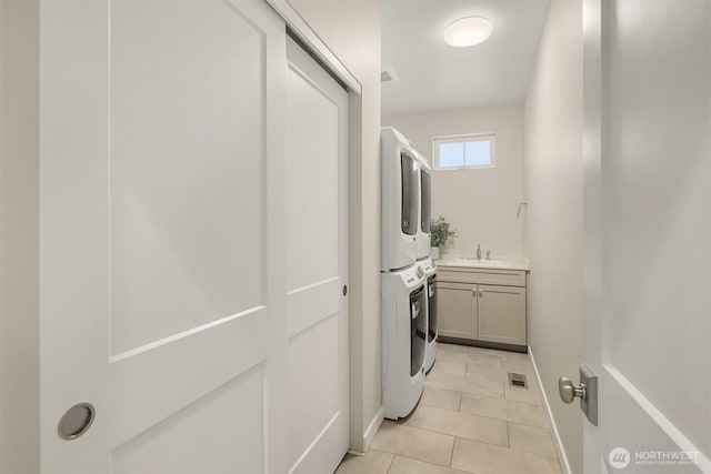 3815 NE 89th St, Seattle, WA 98115 - washroom featuring cabinet space, stacked washing machine and dryer, and light tile patterned floors