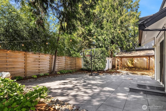 3815 NE 89th St, Seattle, WA 98115 - view of patio with a fenced backyard, an outbuilding, and a shed