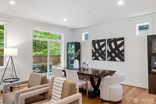 dining space featuring light wood finished floors, healthy amount of natural light, recessed lighting, and baseboards
