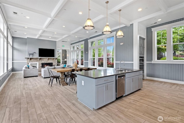kitchen featuring coffered ceiling, gray cabinetry, dishwasher, a sink, and light wood-style flooring
