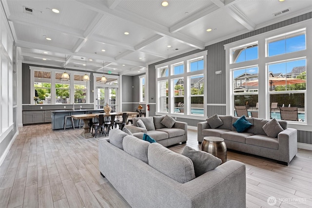 living room with light wood finished floors, coffered ceiling, beamed ceiling, healthy amount of natural light, and recessed lighting