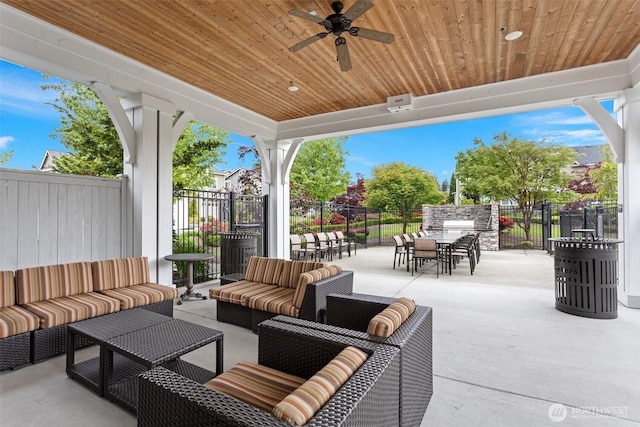 view of patio / terrace featuring an outdoor living space, outdoor dining space, a ceiling fan, and fence