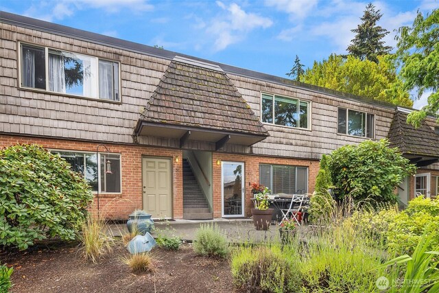 3834 175th Ave NE Unit E49, Redmond, WA 98052 - view of front of home featuring brick siding and mansard roof