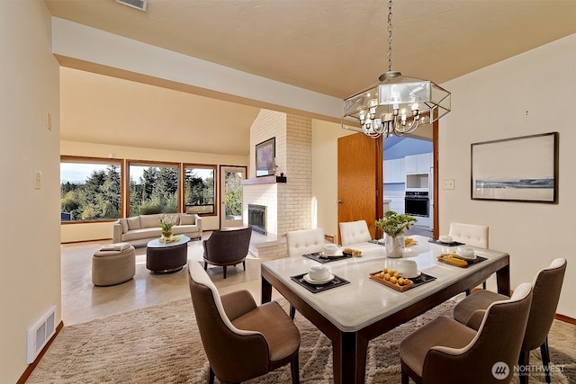 2526 E Pershing Ct, Shelton, WA 98584 - dining room featuring a chandelier, a fireplace, and baseboards
