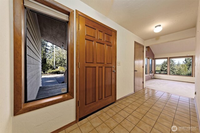 2526 E Pershing Ct, Shelton, WA 98584 - foyer entrance featuring light carpet, baseboards, light tile patterned floors, and vaulted ceiling