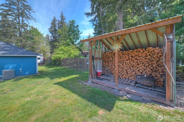 view of yard featuring central air condition unit and an outdoor structure