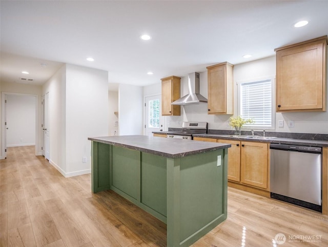 353 Mount Olympus Ave SE, Ocean Shores, WA 98569 - kitchen with appliances with stainless steel finishes, wall chimney exhaust hood, dark countertops, a sink, and light brown cabinetry