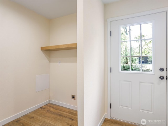 353 Mount Olympus Ave SE, Ocean Shores, WA 98569 - doorway to outside featuring light wood-style flooring and baseboards