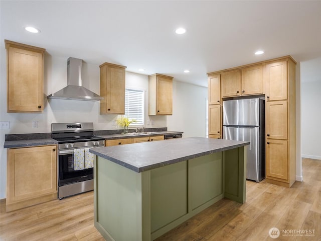353 Mount Olympus Ave SE, Ocean Shores, WA 98569 - kitchen featuring wall chimney range hood, stainless steel appliances, dark countertops, a kitchen island, and light wood-style floors