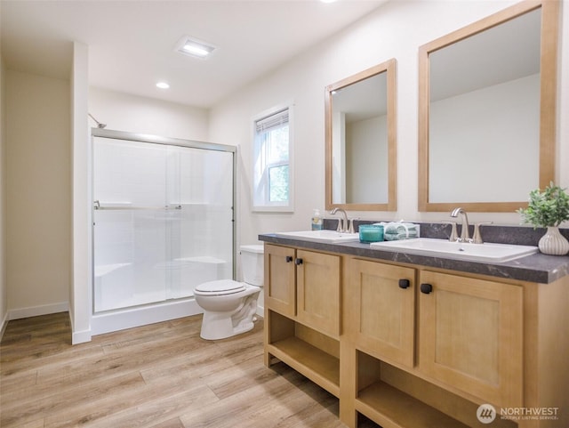 353 Mount Olympus Ave SE, Ocean Shores, WA 98569 - bathroom with toilet, a shower stall, wood finished floors, double vanity, and recessed lighting