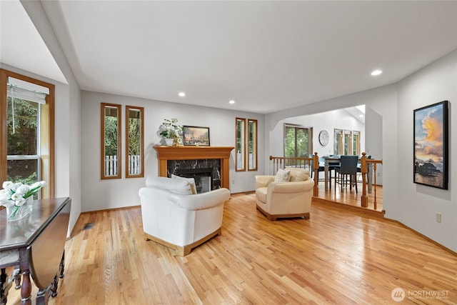 11712 17th Avenue Ct NW, Gig Harbor, WA 98332 - living room featuring light wood finished floors, healthy amount of natural light, recessed lighting, and a high end fireplace