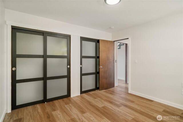12062 Neppel Rd, Moses Lake, WA 98837 - unfurnished bedroom with light wood-style flooring and baseboards