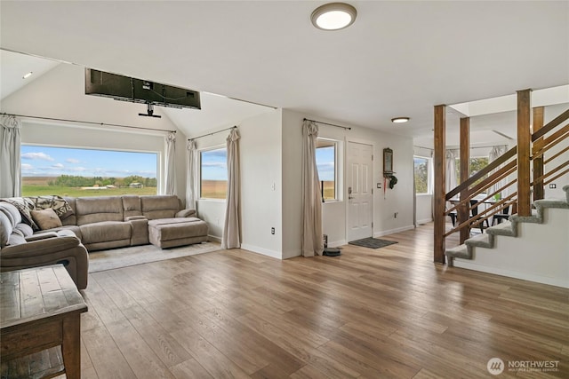 12062 Neppel Rd, Moses Lake, WA 98837 - living area featuring wood finished floors, baseboards, stairs, and vaulted ceiling