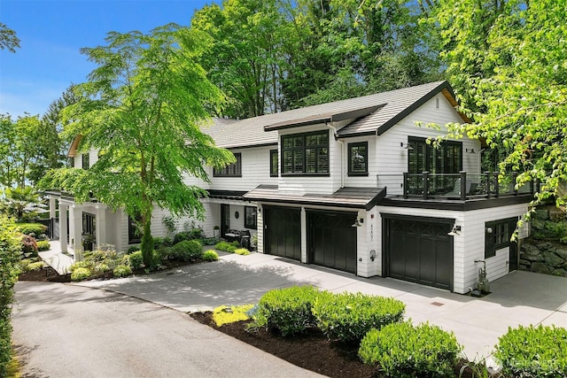 4207 Holly Ln, Mercer Island, WA 98040 - view of front of property with concrete driveway, a garage, and a balcony