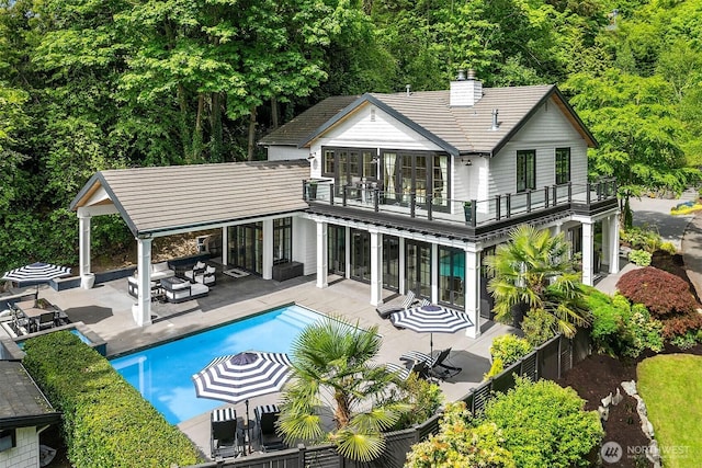 4207 Holly Ln, Mercer Island, WA 98040 - back of house featuring a balcony, a chimney, a patio area, an outdoor living space, and a fenced backyard