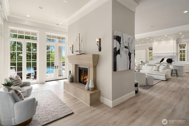4207 Holly Ln, Mercer Island, WA 98040 - living room featuring ornamental molding, light wood-type flooring, a premium fireplace, a towering ceiling, and baseboards