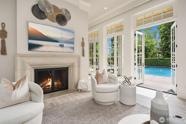 4207 Holly Ln, Mercer Island, WA 98040 - sitting room with wood finished floors, a glass covered fireplace, ornamental molding, and french doors