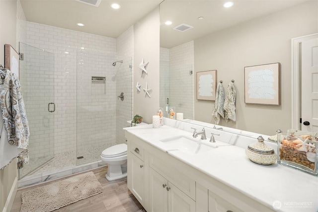 4207 Holly Ln, Mercer Island, WA 98040 - full bath with a stall shower, toilet, wood finished floors, vanity, and recessed lighting