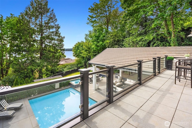 4207 Holly Ln, Mercer Island, WA 98040 - view of pool with a water view, a patio area, and a pool with connected hot tub