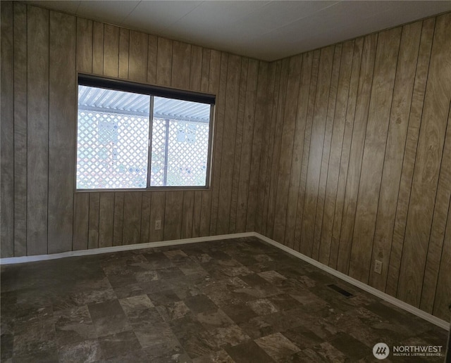 empty room with wooden walls