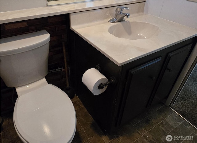 bathroom featuring toilet and vanity
