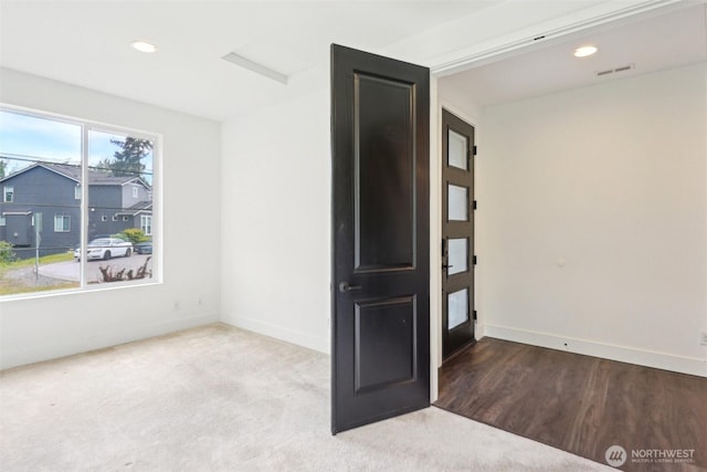 carpeted spare room featuring baseboards and recessed lighting