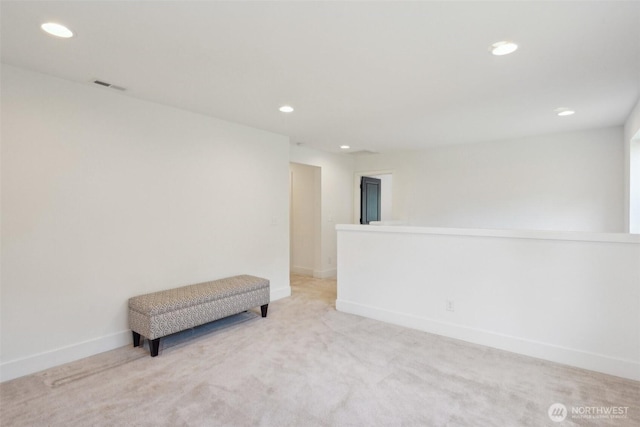 spare room with recessed lighting, baseboards, and light carpet