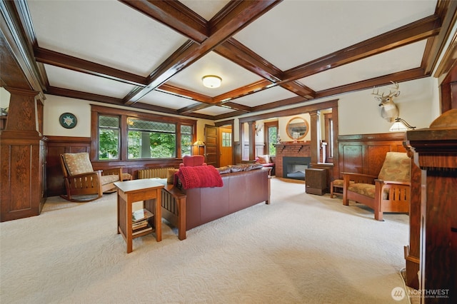carpeted living room with a brick fireplace, healthy amount of natural light, beam ceiling, coffered ceiling, and decorative columns