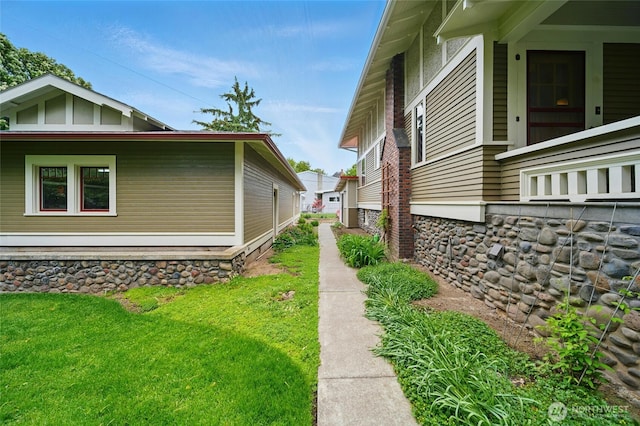 view of side of home featuring a yard