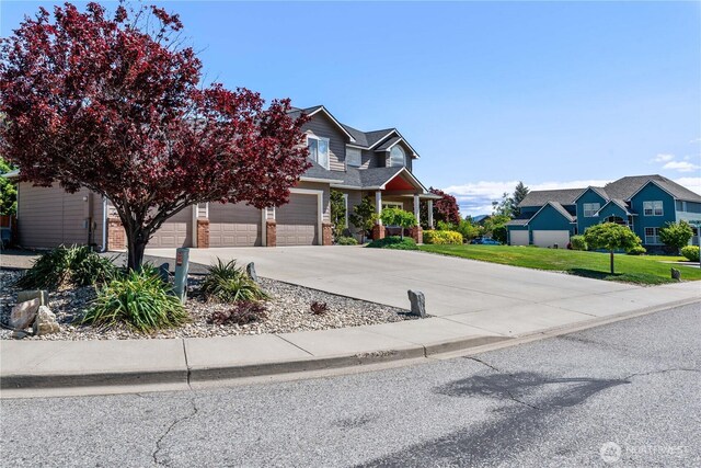 2149 Inglewood Dr, East Wenatchee, WA 98802 - view of front of property with driveway, a garage, a residential view, and a front yard