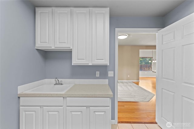 2149 Inglewood Dr, East Wenatchee, WA 98802 - washroom with a sink, baseboards, and light wood-style flooring