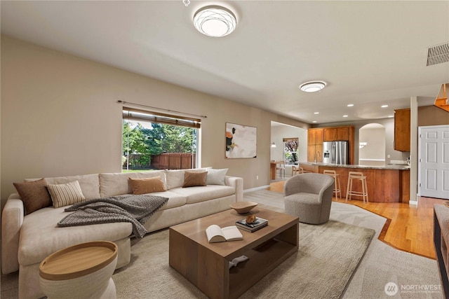 2149 Inglewood Dr, East Wenatchee, WA 98802 - living room with light wood finished floors, arched walkways, recessed lighting, and baseboards