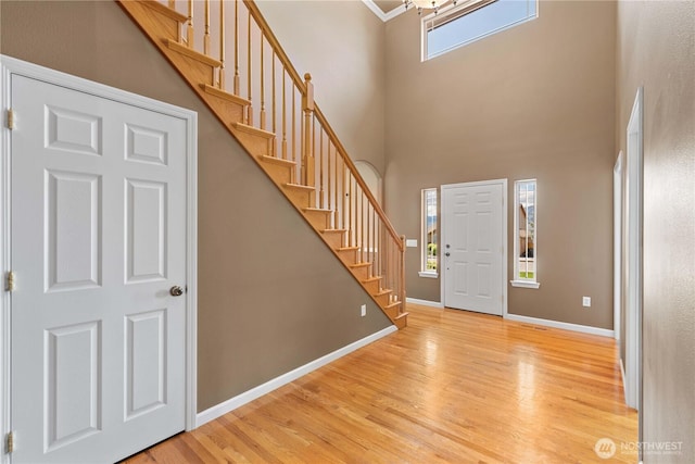2149 Inglewood Dr, East Wenatchee, WA 98802 - entrance foyer with light wood finished floors, stairway, a high ceiling, baseboards, and a chandelier