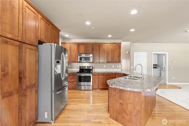 2149 Inglewood Dr, East Wenatchee, WA 98802 - kitchen with stainless steel appliances, a sink, a peninsula, brown cabinetry, and recessed lighting