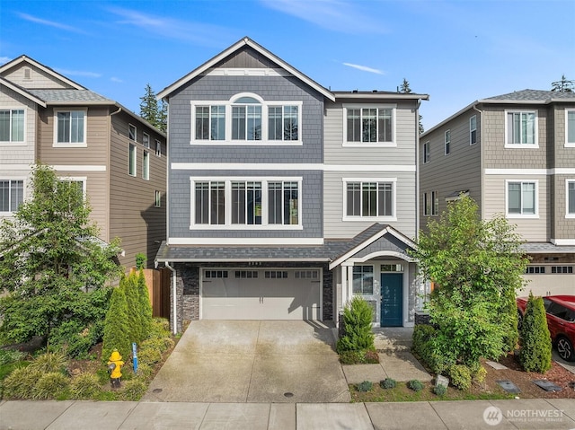 3303 103rd Dr NE, Lake Stevens, WA 98258 - view of front of home with a garage, concrete driveway, and stone siding