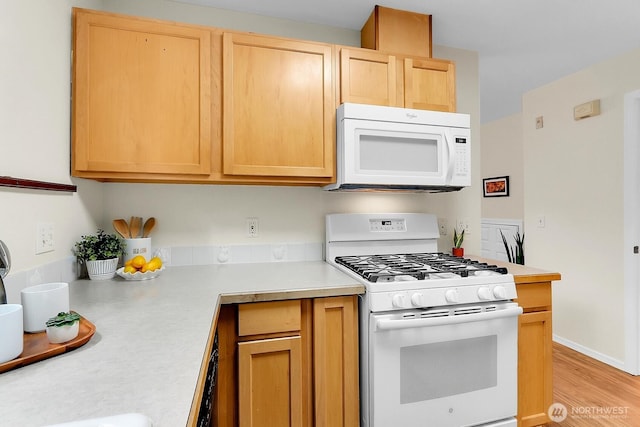 12549 Roosevelt Way NE Unit 13, Seattle, WA 98125 - kitchen with white appliances, light countertops, light brown cabinetry, and light wood-style flooring