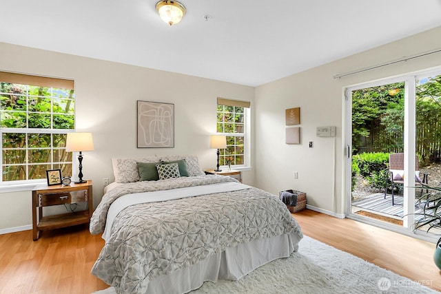 12549 Roosevelt Way NE Unit 13, Seattle, WA 98125 - bedroom with access to exterior, light wood finished floors, and baseboards