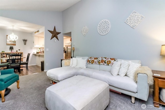 2949 Mile Hill Dr SE Unit C7, Port Orchard, WA 98366 - living room featuring lofted ceiling, a chandelier, and carpet