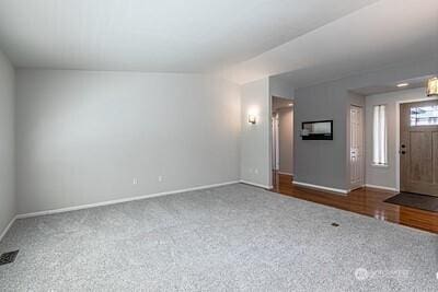 2117 130th Dr NE, Lake Stevens, WA 98258 - unfurnished living room with baseboards and carpet floors